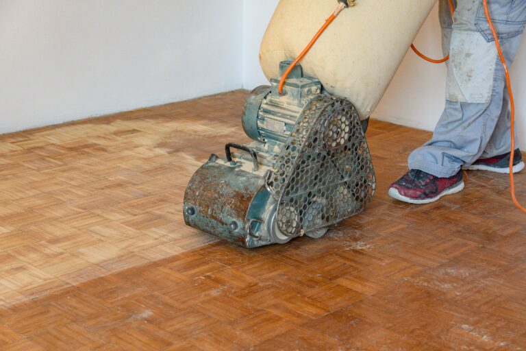 Man sanding hardwood floor with grinding machine 2025 03 05 22 29 19 utc